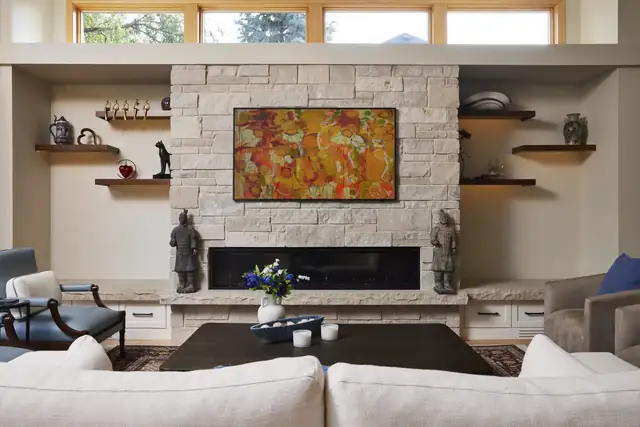 Fireplace feature wall remodel in Edina, Minnesota with a linear gas fireplace, custom ledge stone blend and tape lighting