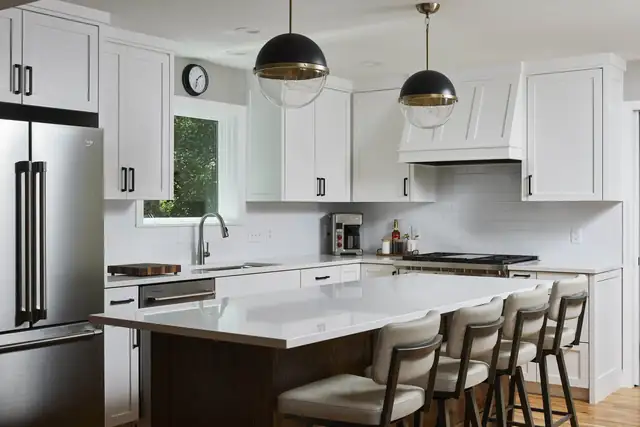 Kitchen remodel in St. Louis Park, Minnesota with a red oak stained island, white cabinetry, globe pendants and a hidden pantry in modern farmhouse style