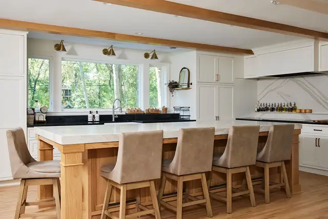 St. Louis Park, Minnesota kitchen with a natural wood island, Cambria top, soapstone counters, white cabinets and brass sconces